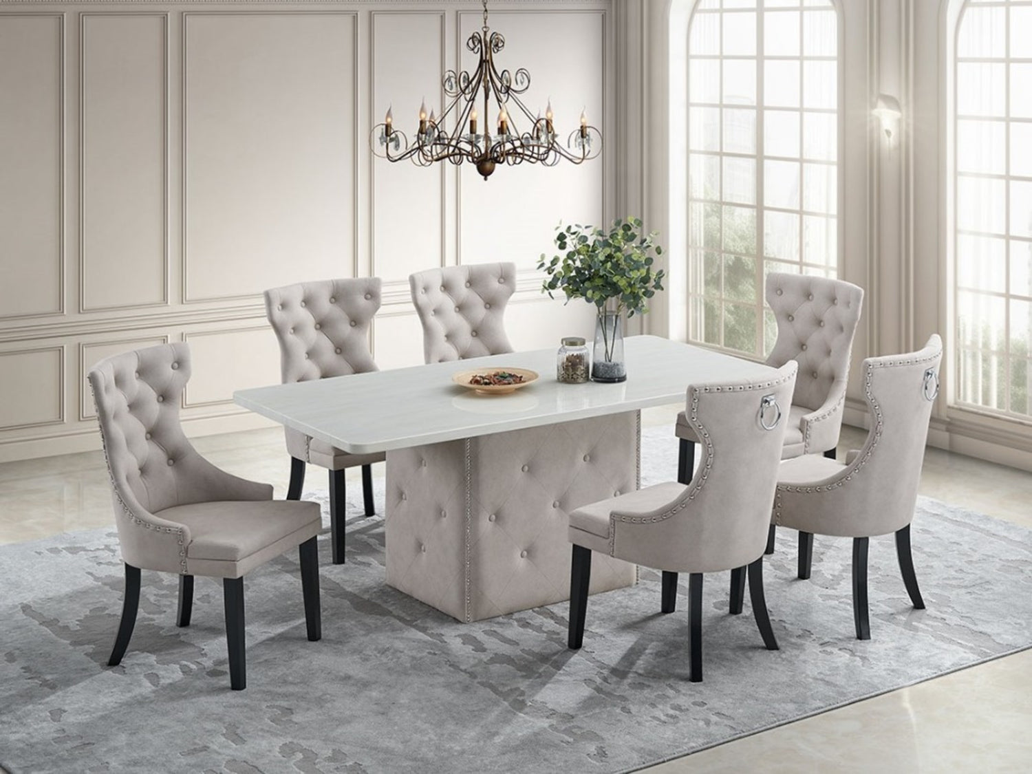 Dining room with a marble table and tufted chairs in a well-lit room.